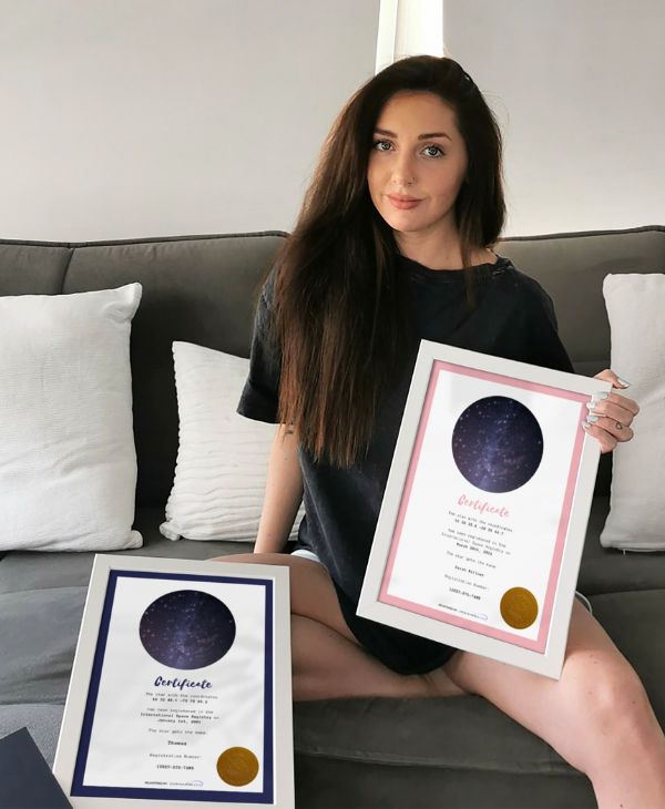 Young woman showing her two star-naming certificates